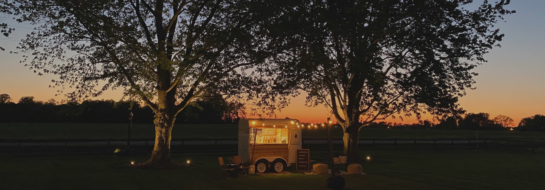 The Pouring Happiness vintage coffee trailer at sunset