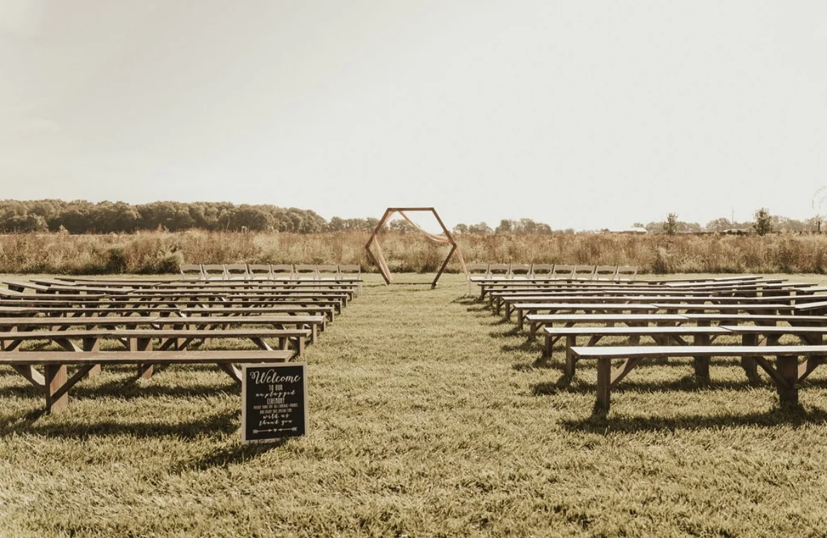 Outdoor ceremony benches arranged across the lawn
